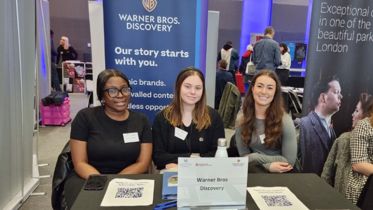 Three reps from Warner Bros sat at their stand at the University of West London's Creative Careers Fair